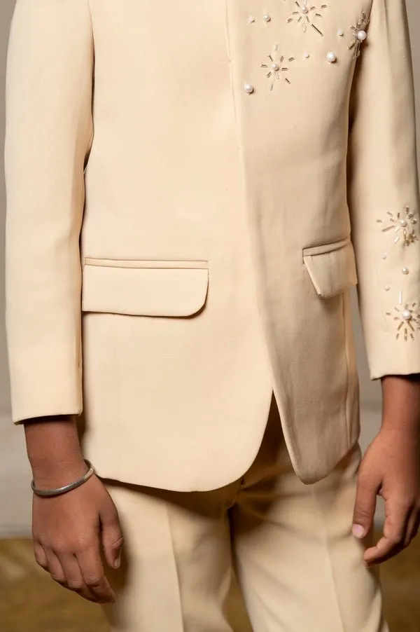 Elegant light beige bandhgala suit with delicate floral embroidery, paired with matching slim-fit trousers for a refined and sophisticated look