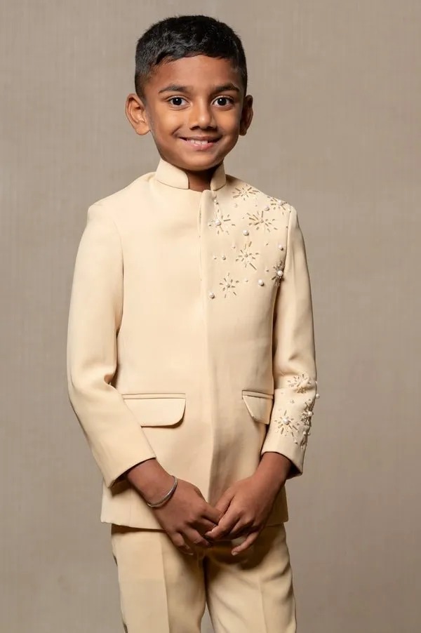 Elegant light beige bandhgala suit with delicate floral embroidery, paired with matching slim-fit trousers for a refined and sophisticated look